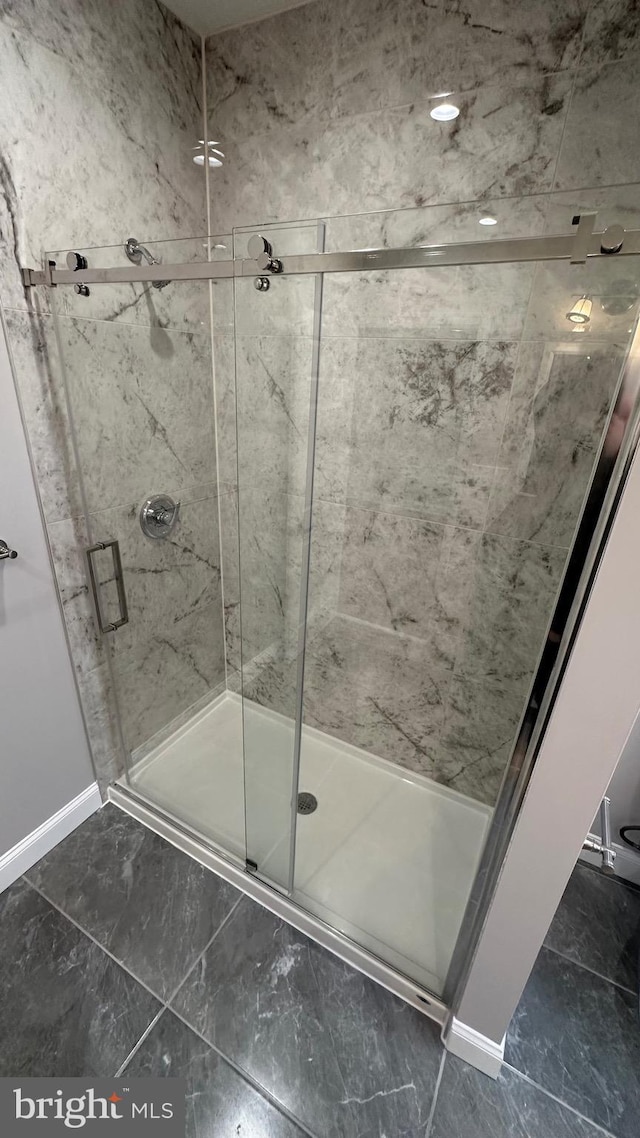 bathroom featuring a shower with shower door