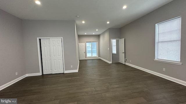 interior space with dark hardwood / wood-style floors and a wealth of natural light