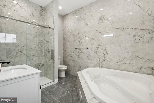 full bathroom featuring vanity, tile walls, toilet, and separate shower and tub