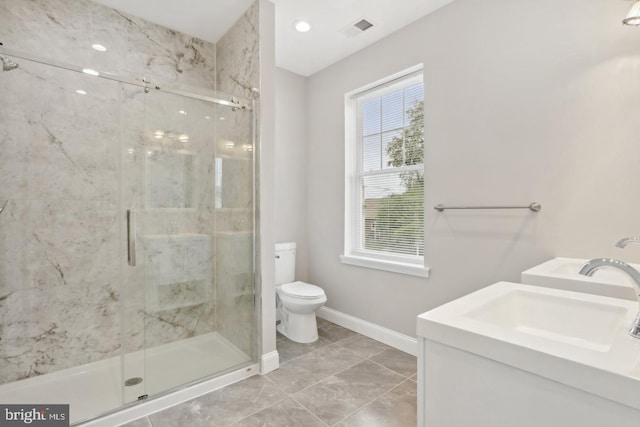 bathroom with an enclosed shower, vanity, tile patterned flooring, and toilet