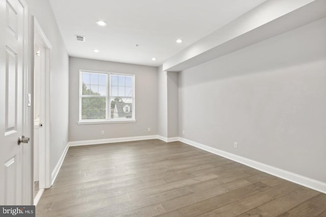 spare room with wood-type flooring