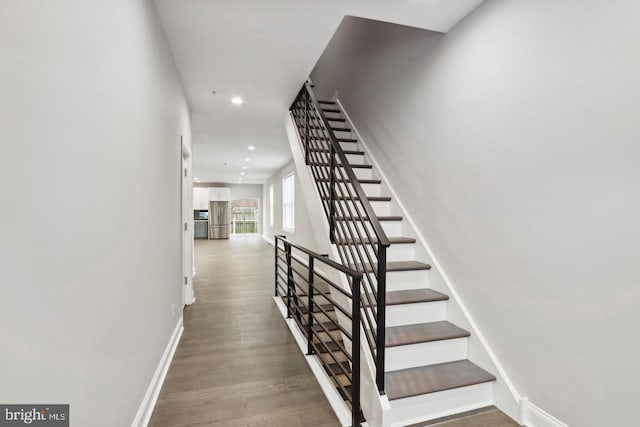 stairs featuring wood-type flooring