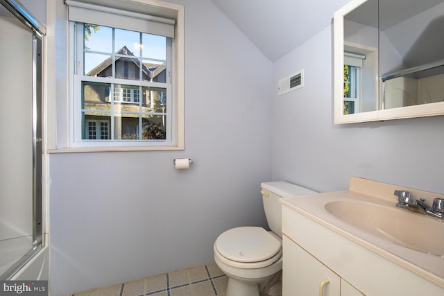 full bathroom with vanity, lofted ceiling, combined bath / shower with glass door, and toilet