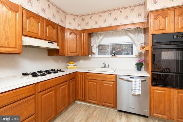 kitchen with white gas stovetop, sink, double oven, and stainless steel dishwasher