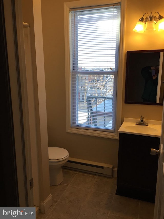 bathroom featuring a baseboard radiator, vanity, tile patterned floors, and toilet