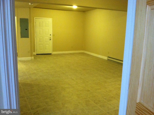 spare room with electric panel and a baseboard heating unit