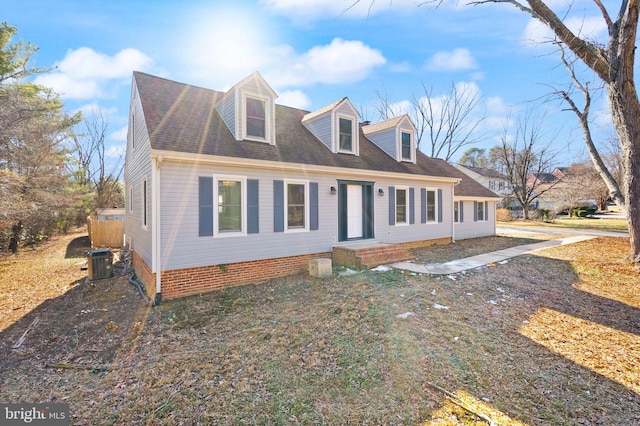 cape cod-style house featuring central AC unit