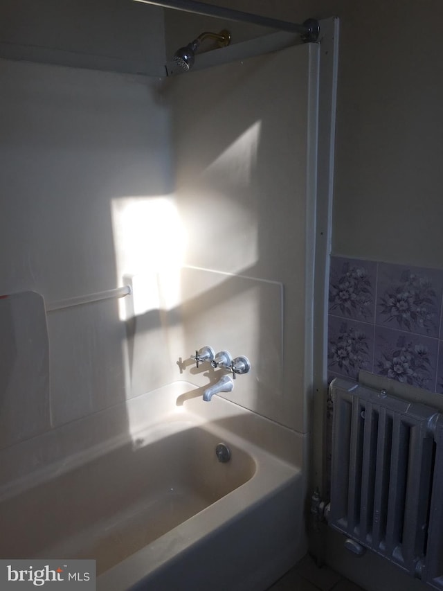 bathroom with radiator and tub / shower combination