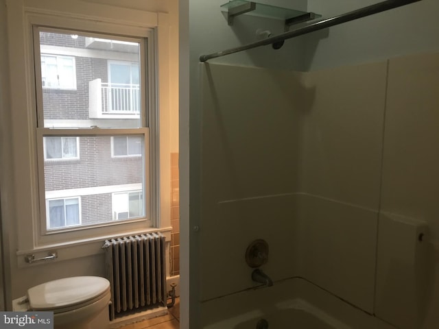 bathroom with radiator heating unit, toilet, and shower / bath combination