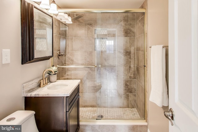 bathroom with vanity, an enclosed shower, and toilet