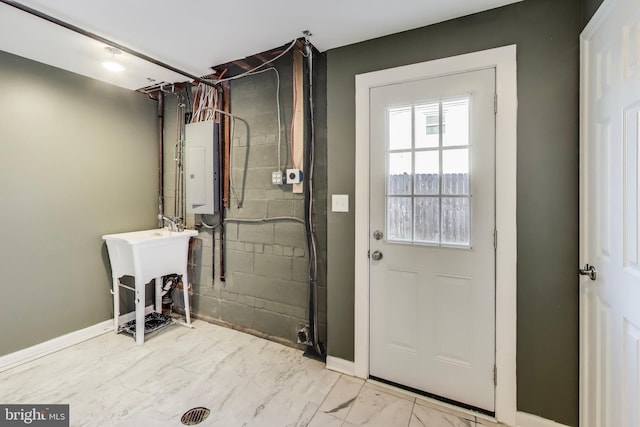 doorway to outside with sink and electric panel