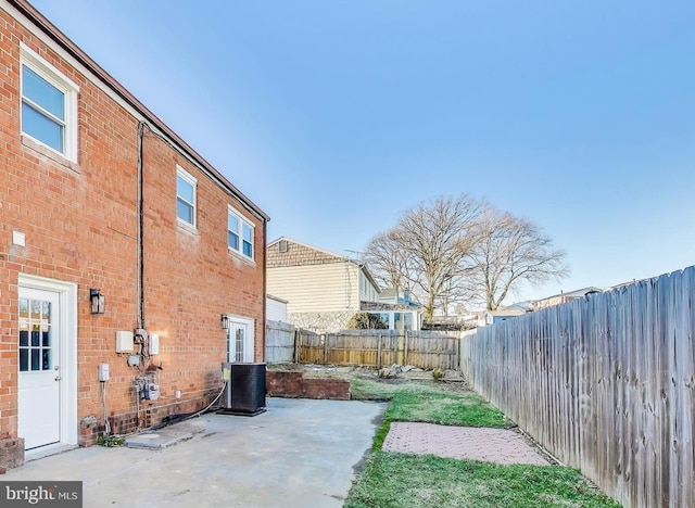 view of yard with central AC unit and a patio area