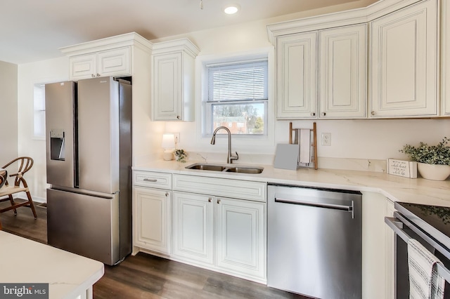 kitchen with stainless steel appliances, dark hardwood / wood-style floors, sink, and white cabinets