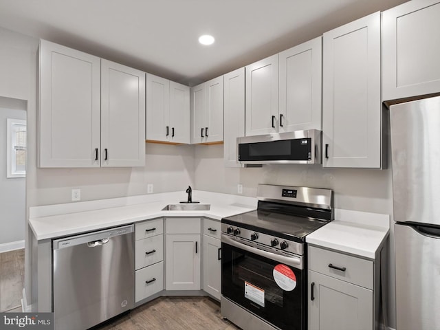 kitchen with white cabinetry, appliances with stainless steel finishes, and sink