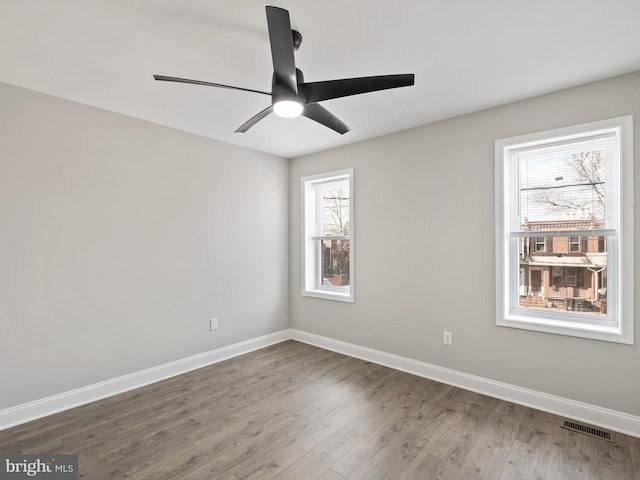 unfurnished room with dark wood-type flooring and ceiling fan