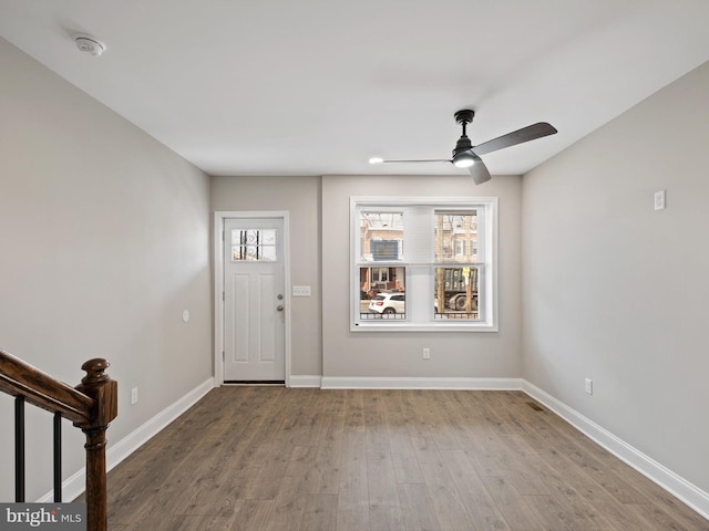 entryway with wood-type flooring and ceiling fan