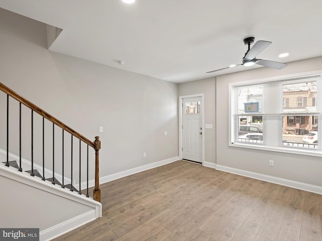 foyer entrance featuring ceiling fan and light wood-type flooring