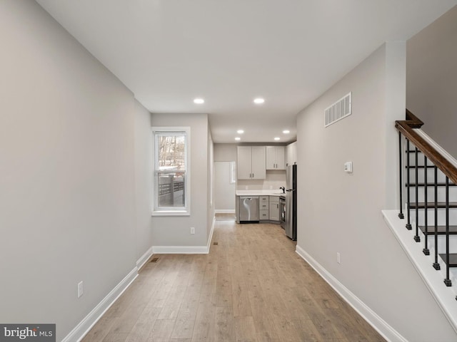 unfurnished living room with light wood-type flooring