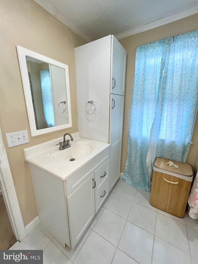 bathroom featuring crown molding, vanity, and tile patterned flooring