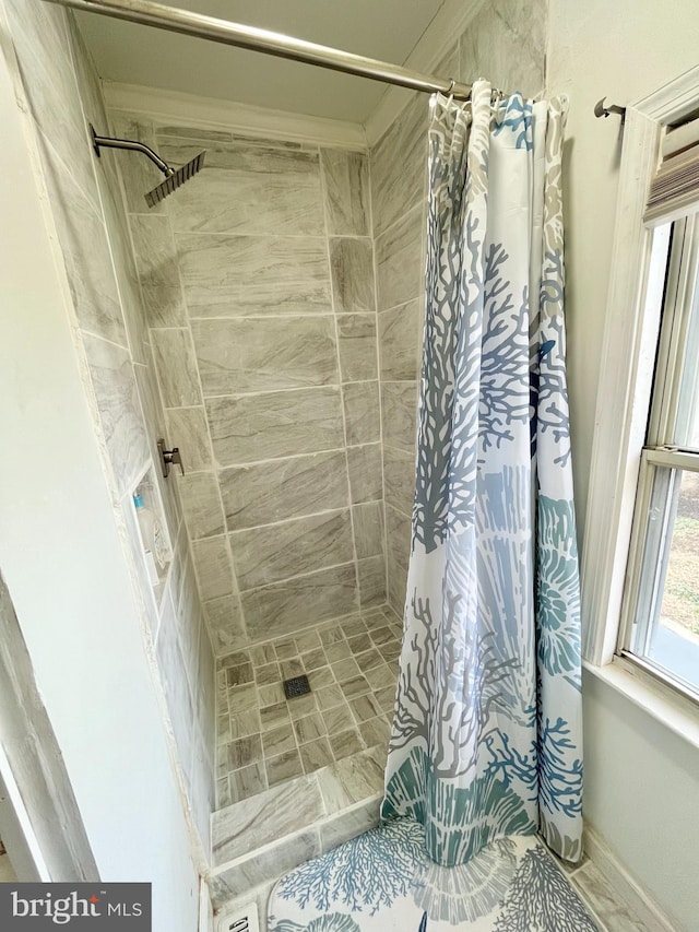 bathroom featuring ornamental molding and a shower with shower curtain