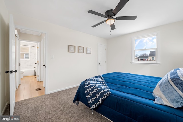 bedroom featuring ceiling fan, carpet floors, and ensuite bath