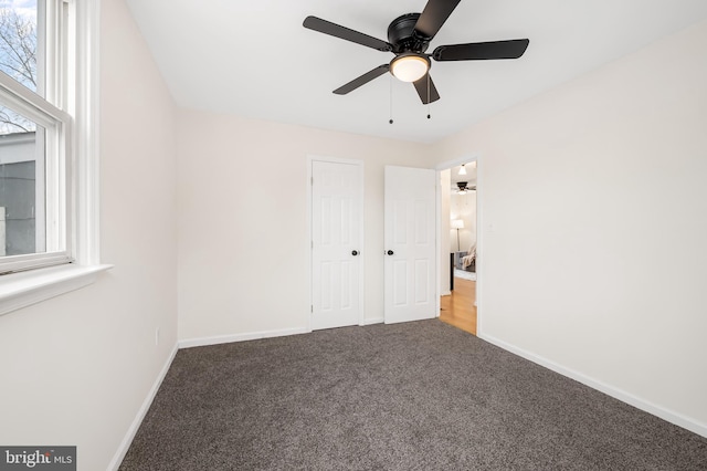 unfurnished bedroom with ceiling fan and carpet