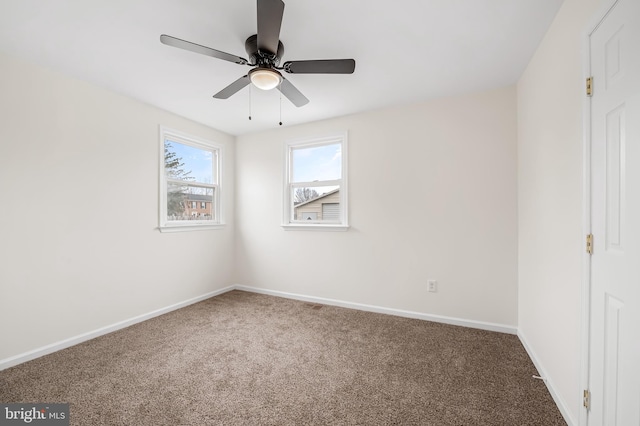 unfurnished room with ceiling fan and carpet