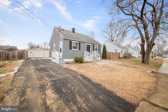 bungalow-style house with an outbuilding and a garage