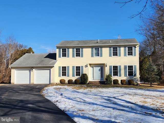 colonial-style house with an attached garage and driveway