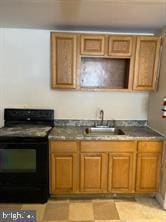 kitchen featuring black / electric stove and sink