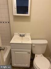 bathroom featuring vanity and toilet