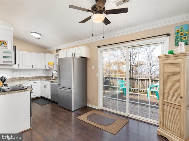 kitchen featuring sink, ornamental molding, stainless steel appliances, decorative backsplash, and white cabinets