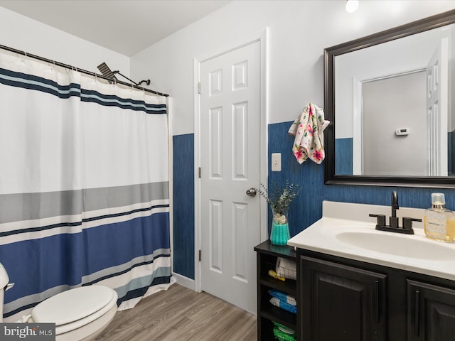 bathroom featuring hardwood / wood-style flooring, vanity, and toilet