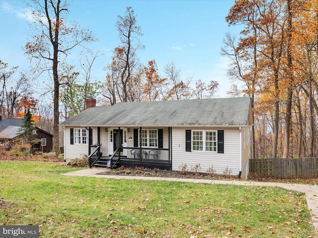 single story home featuring a front lawn and covered porch