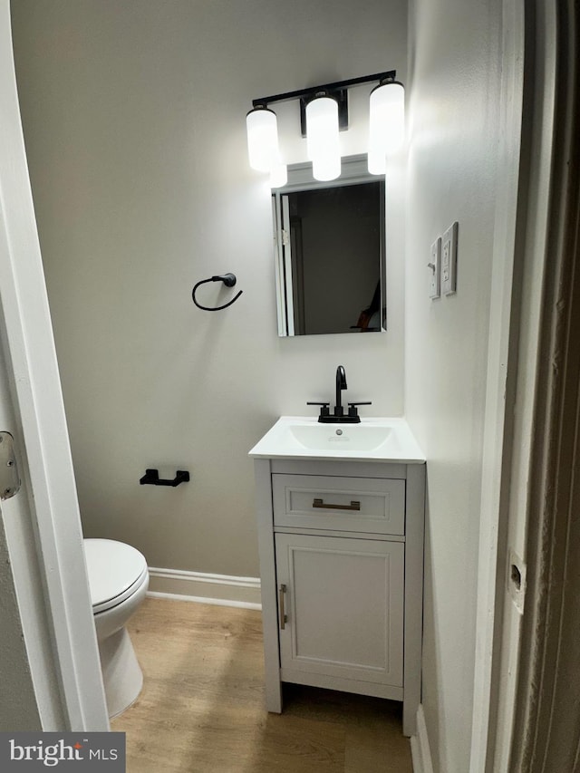 bathroom featuring vanity, toilet, and wood-type flooring