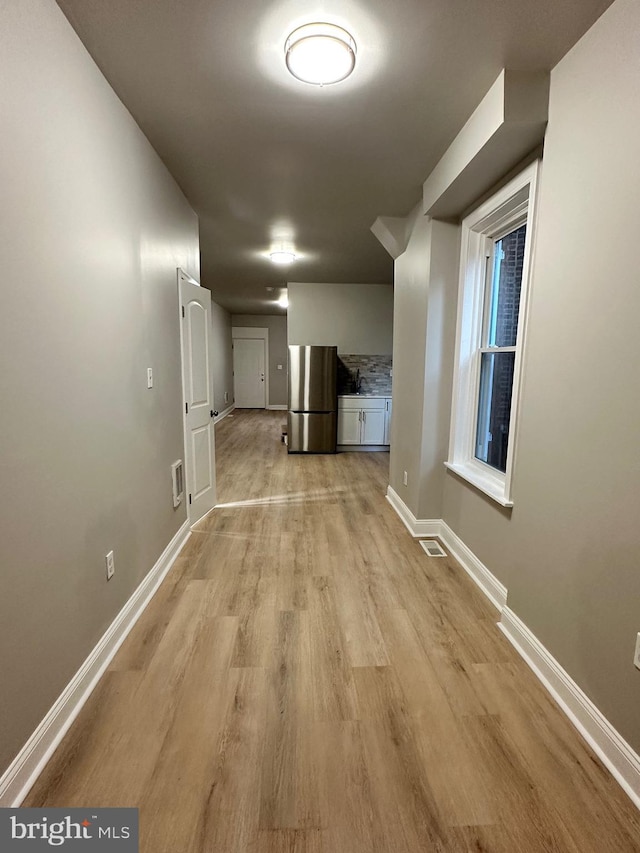 hallway with light wood-type flooring