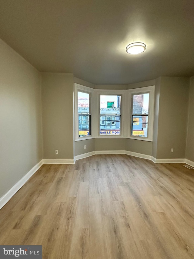 empty room with light wood-type flooring