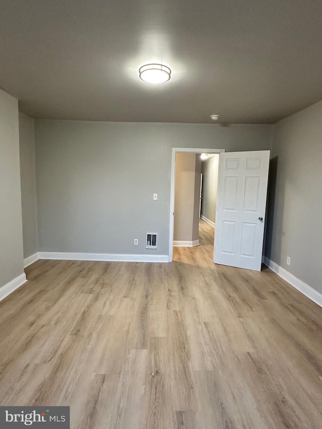 empty room with light hardwood / wood-style floors