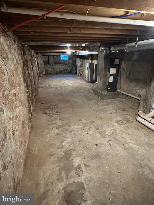 basement with electric water heater and heating unit