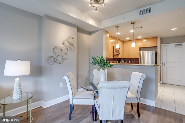 dining room with wood-type flooring