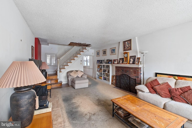 living room with carpet floors, a brick fireplace, and a textured ceiling