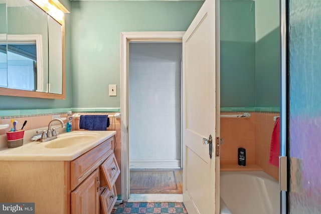 bathroom with vanity and a bath