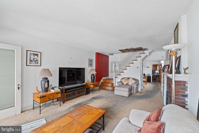 carpeted living room with a brick fireplace and a textured ceiling