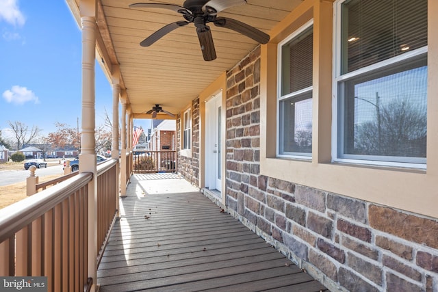 wooden deck with ceiling fan and a porch