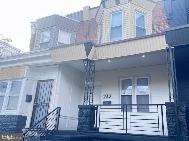 view of exterior entry featuring a porch