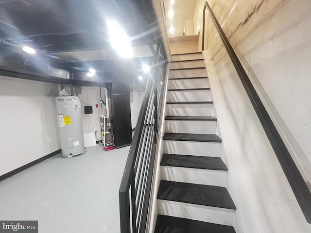 stairs featuring concrete flooring, electric water heater, and heating unit