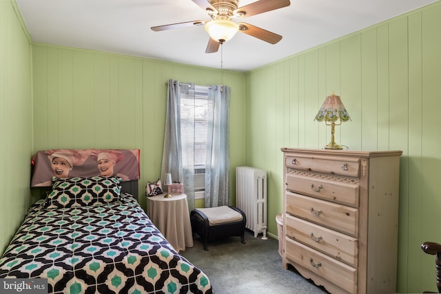 bedroom featuring ceiling fan, radiator, and carpet