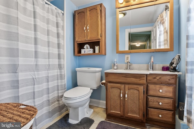 bathroom with vanity, toilet, and tile patterned flooring