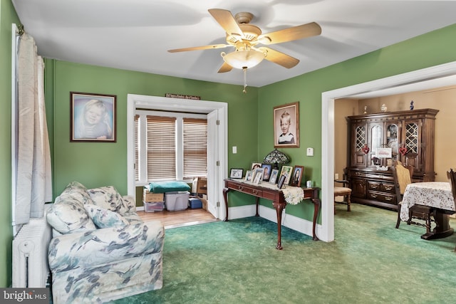 interior space with ceiling fan and carpet