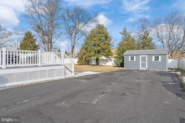 exterior space featuring a wooden deck and an outdoor structure